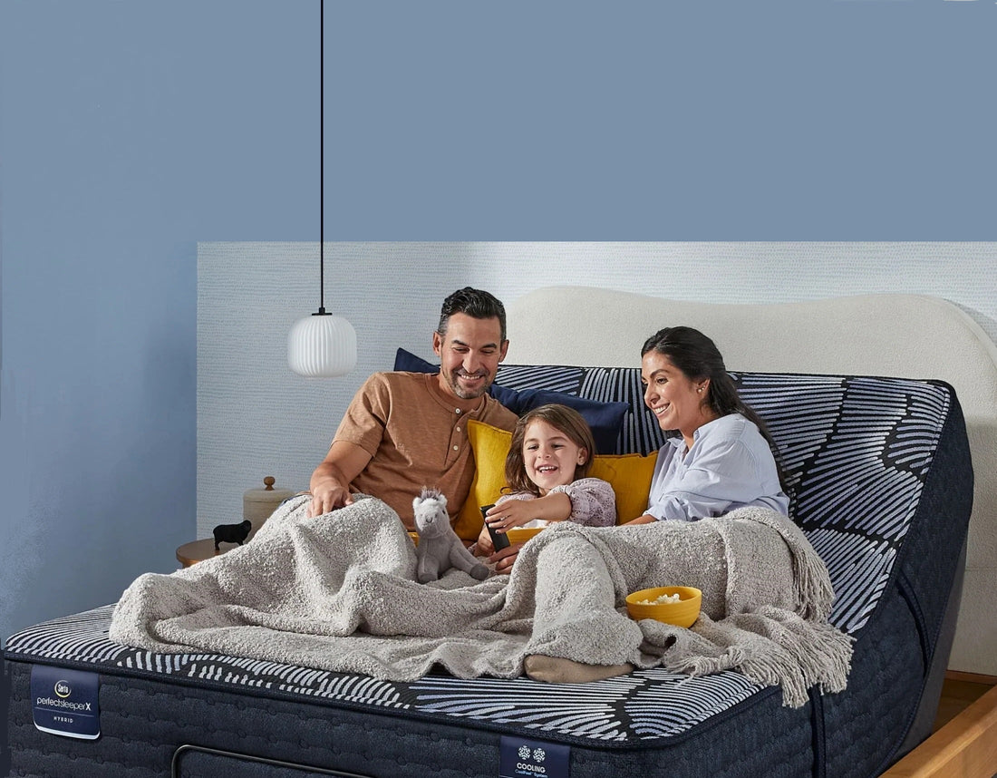 Smiling family laying on Serta mattress