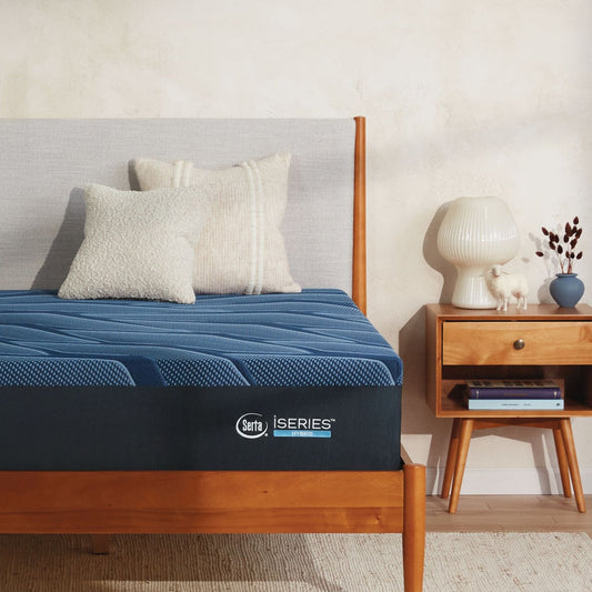 A wooden bed with a Serta iSeries firm blue mattress, 2 beige pillows on top of it||feel: firm||level: enhanced