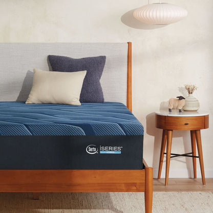 A wooden bed with a Serta iSeries plush blue mattress, blue and beige pillows||feel: plush||level: Ultimate