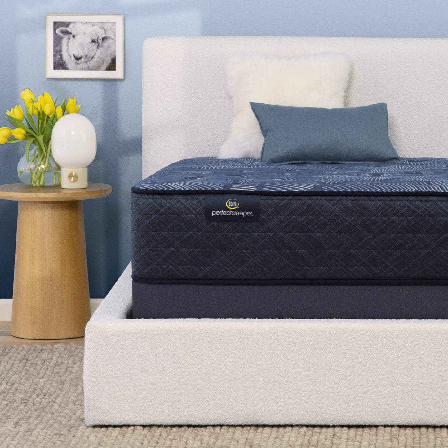 Perfect Sleeper mattress sitting on top of the Serta foundation with both in a white bed frame