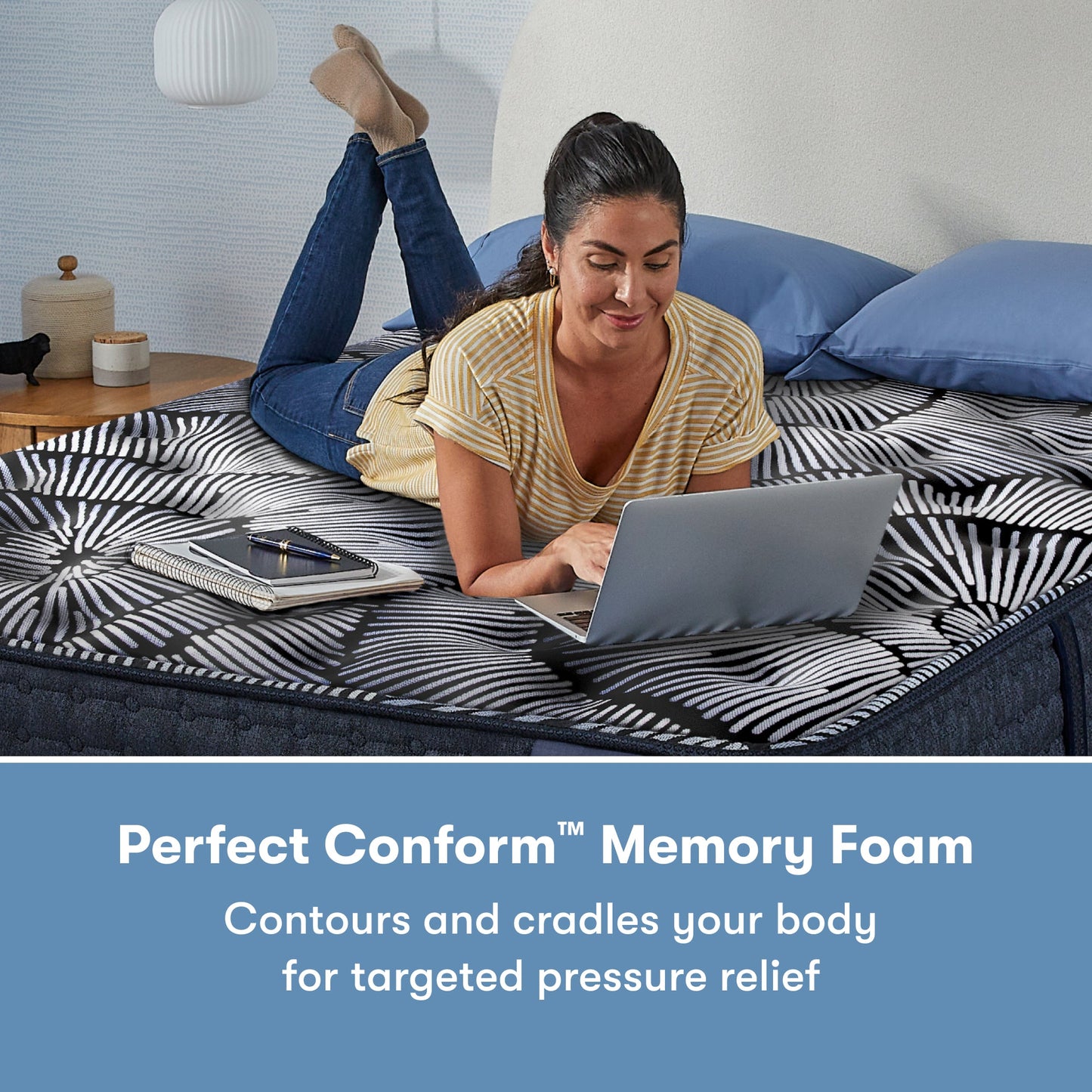 Woman laying on her stomach using her laptop on a Perfect Sleeper X Quilted Hybrid Knox Firm Mattress || feel: Firm || level: Level 1