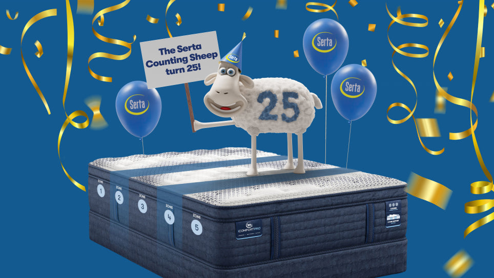  image of the Serta sheep  with the number 25 on its right side, standing on a Serta iComfort Pro mattress holding a sign stating the Serta counting sheep turns 25