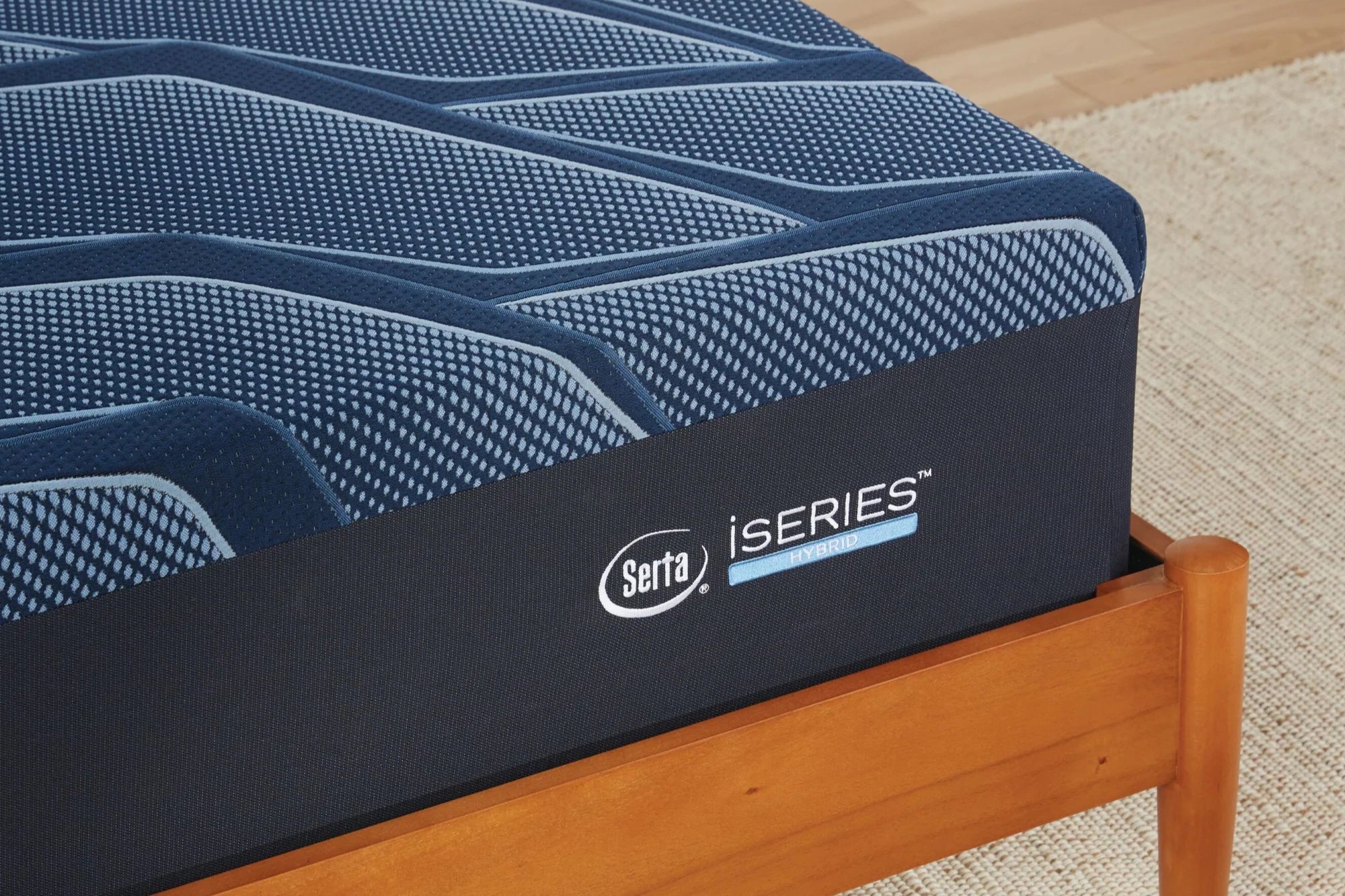 Close-up of a Serta iSeries Hybrid Medium mattress, showcasing its cool-to-the-touch cover, cooling foams, and individually wrapped coils for responsive support.