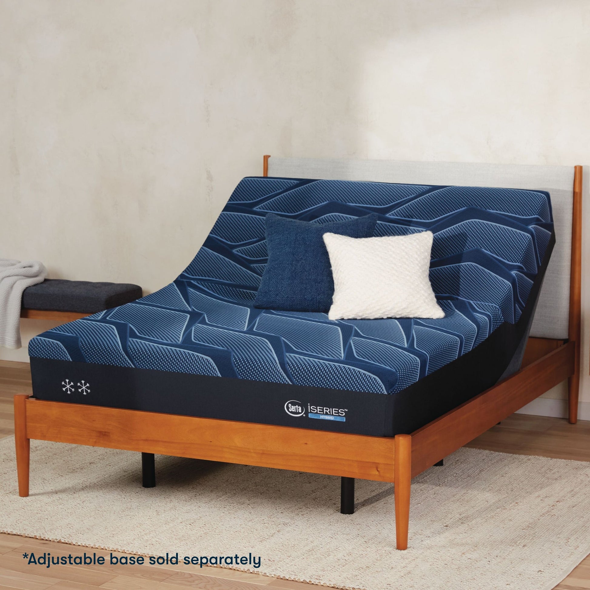 Serta iSeries medium blue mattress sitting in a adjustable frame, in a brown bed with a blue and white pillow on top||feel: medium||level: standard