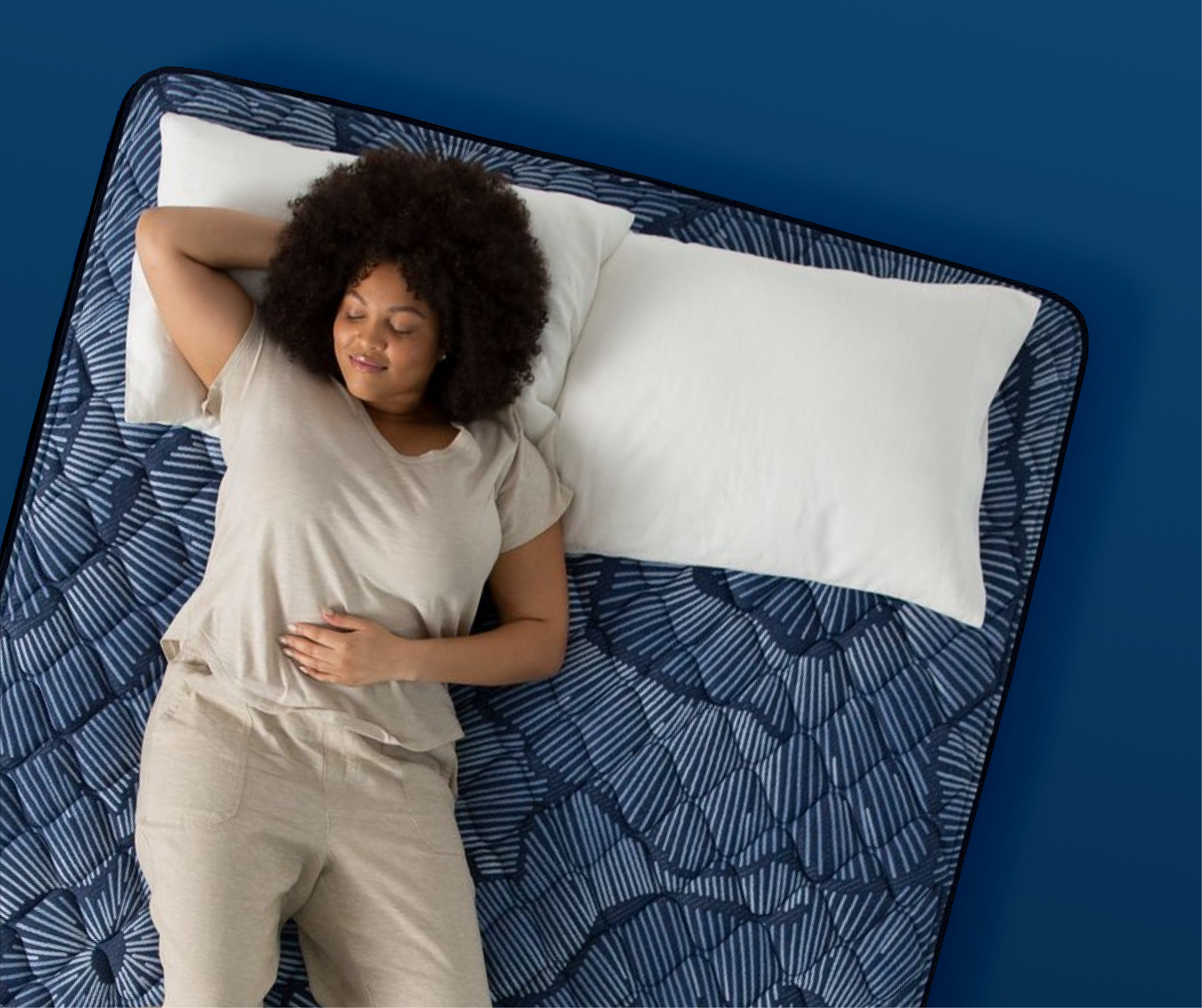 Woman lying on her back on a medium-firm Serta mattress, highlighting support for back sleepers.