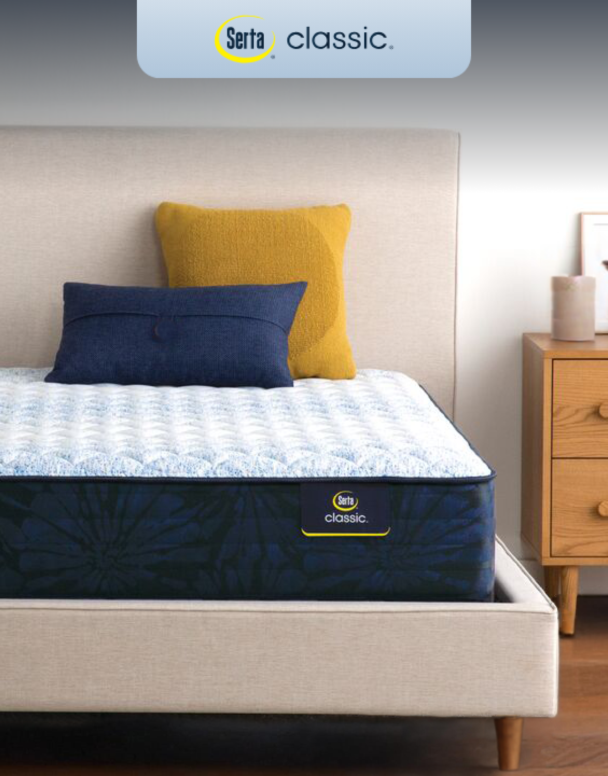 Serta Classic mattress on a modern upholstered bed, highlighting its three-zone lower back support, breathable fabrics, and responsive coils for classic comfort.