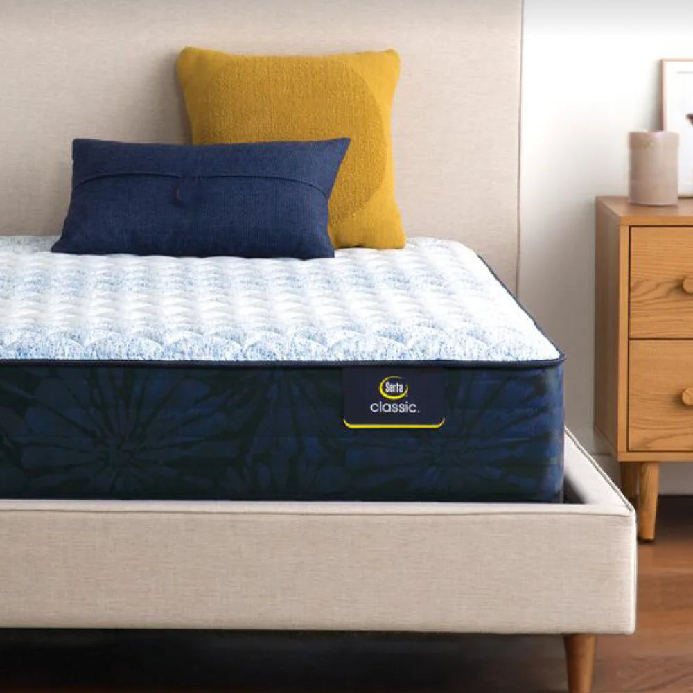 Serta Classic mattress on a modern upholstered bed, highlighting its three-zone lower back support, breathable fabrics, and responsive coils for classic comfort.