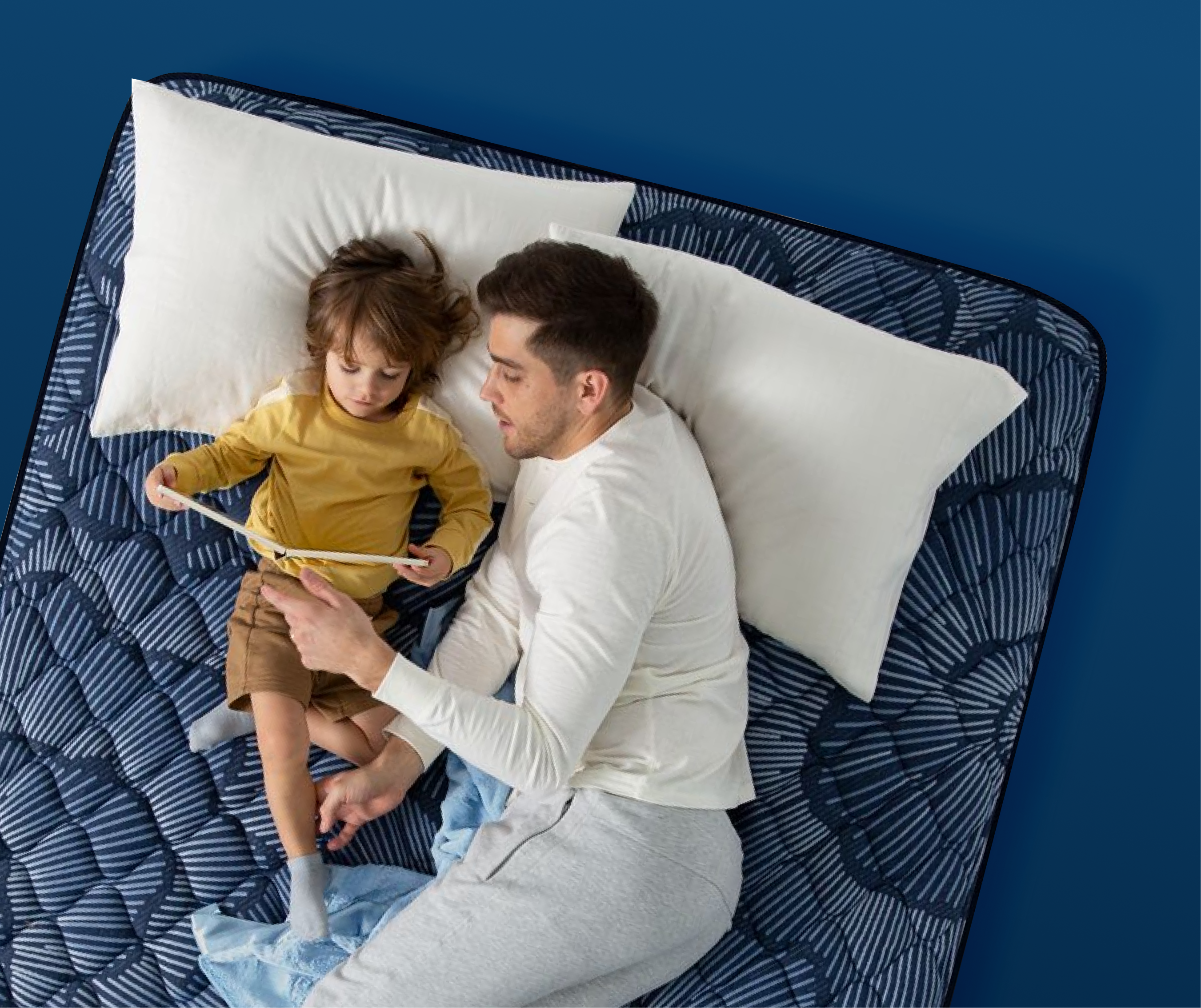 Man and child lying on a Serta mattress, representing comfort for combination sleepers who switch positions at night.