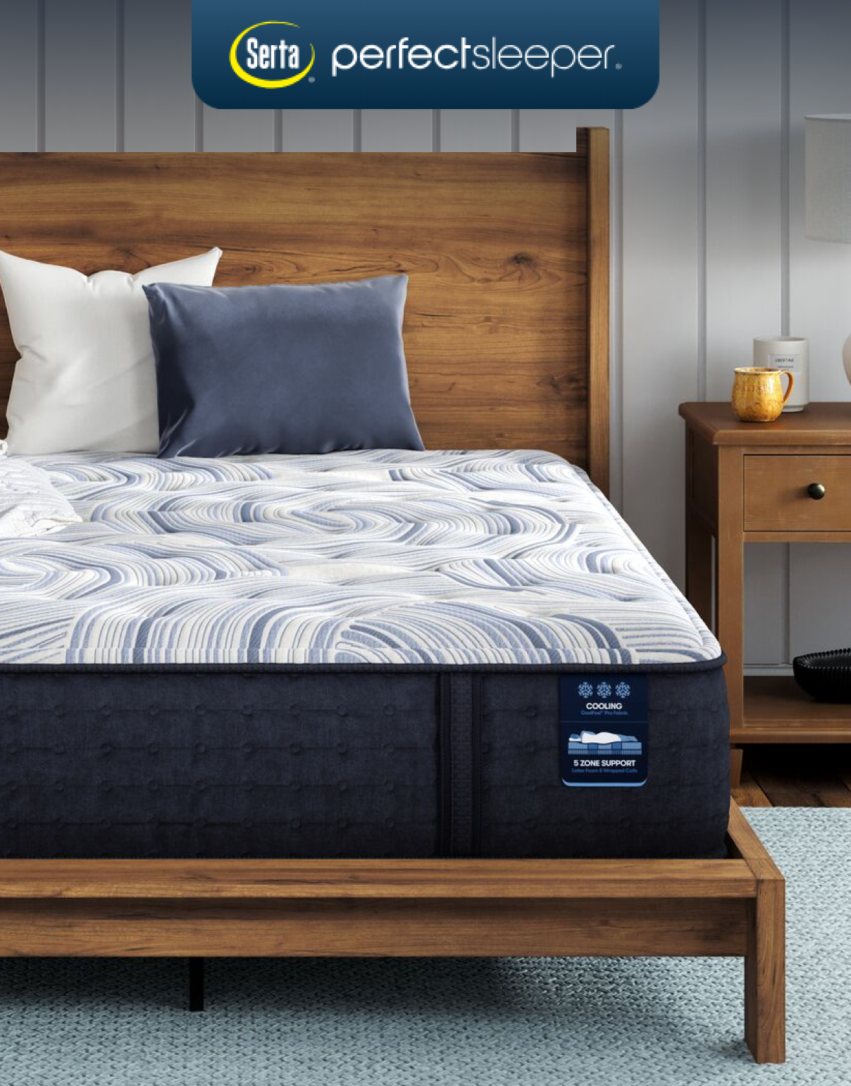 Serta Perfect Sleeper mattress on a wooden bed, featuring up to 5 support zones, pressure-relieving memory foam, and options for foam, hybrid, or innerspring construction.