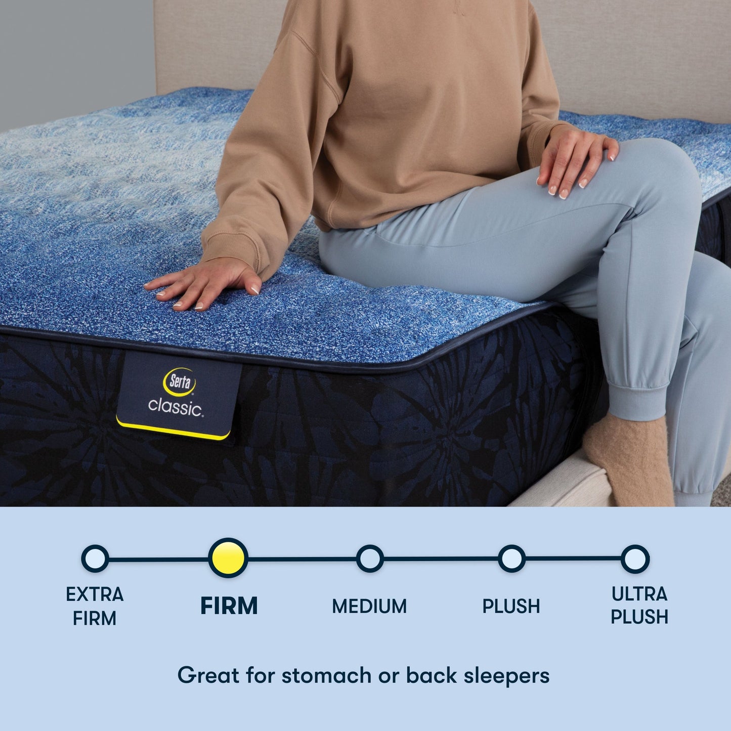 Woman sitting on a Serta classic firm mattress with her right hand placed on the mattress ||feel: firm ||level: enhanced