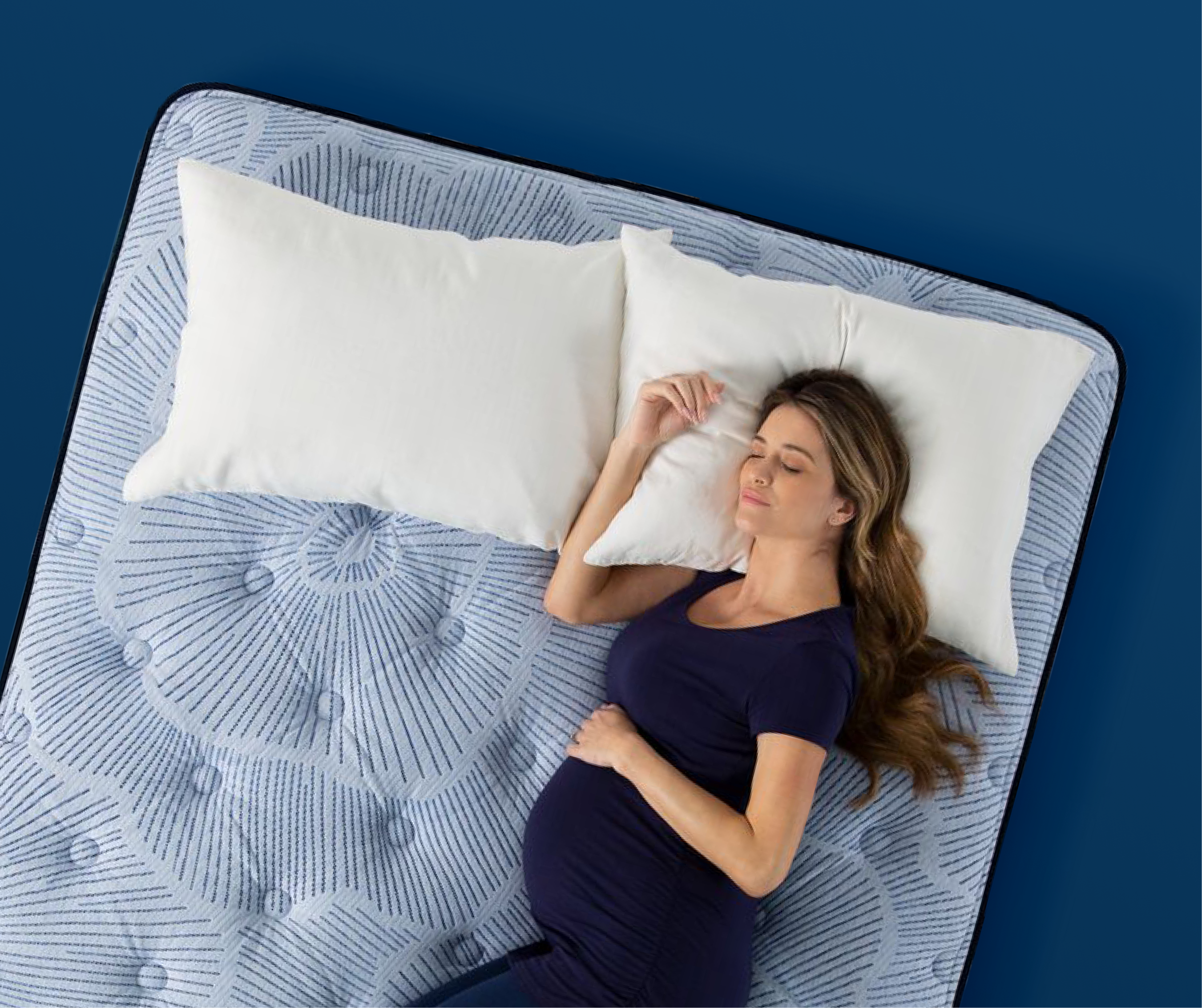 Pregnant woman sleeping on her side on a plush Serta mattress, illustrating ideal comfort for side sleepers.