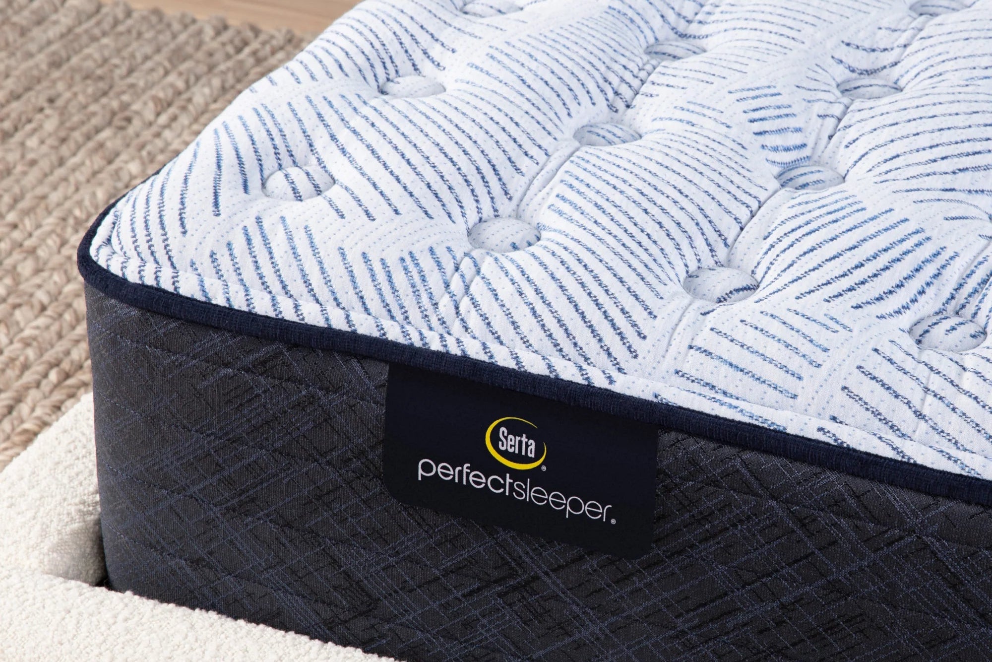 Close-up of a Serta Perfect Sleeper Innerspring Medium mattress, featuring a 13.5-inch profile, cooling features, and targeted support.