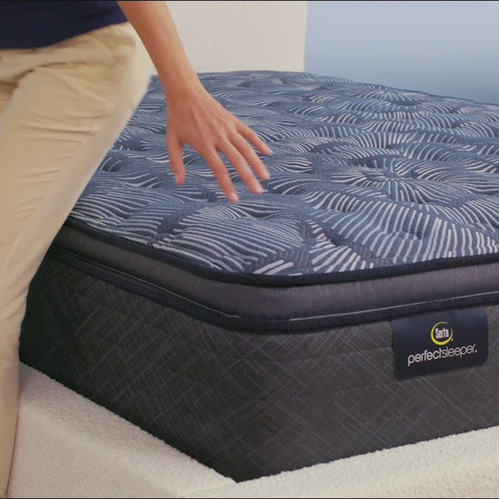 Person sitting on bed to show firmness level of Serta Perfect Sleeper plush mattress||feel: medium pillow top||level: ultimate